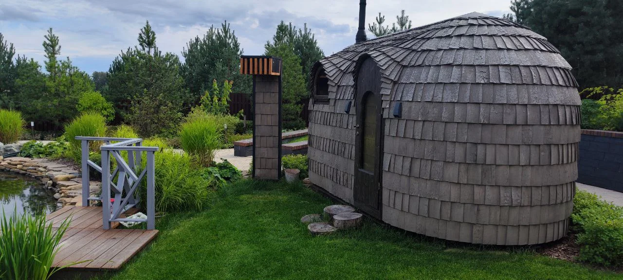 Handcrafted HobbitHut sauna among trees