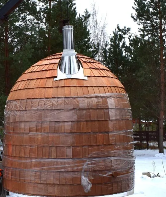 Wood-shingle exterior and chimney among trees